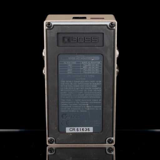 Back view of a Boss digital delay effects pedal on a black background