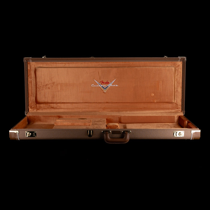 Brown guitar case with Fender logo on a white background