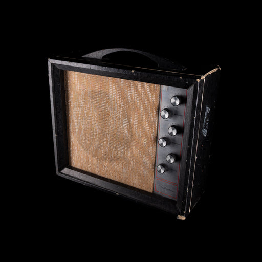 Vintage-style guitar amplifier with wooden front panel on a black background