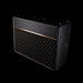 Black guitar amplifier with grille on a black background