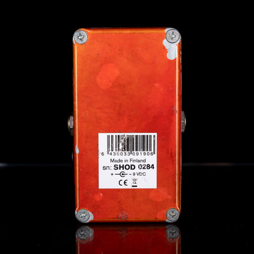 Red electronic device with a barcode label on a black background