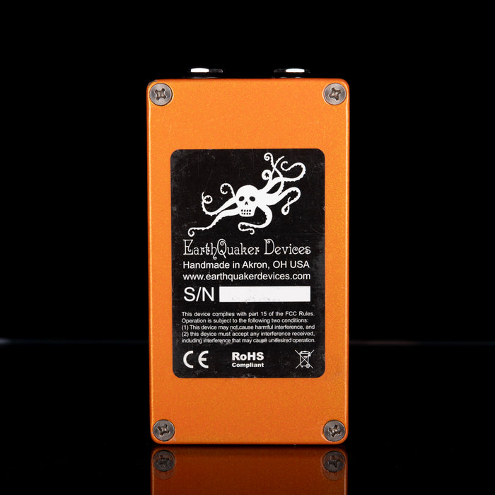 Orange electronic device with EarthQuaker Devices branding on a black background