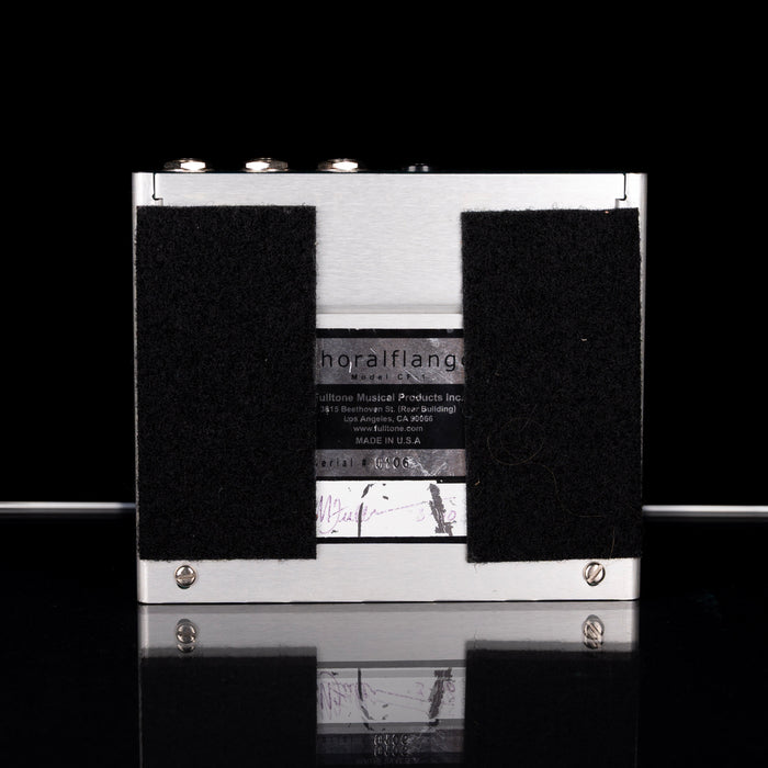 Black and white cassette tape with visible branding on a reflective surface.