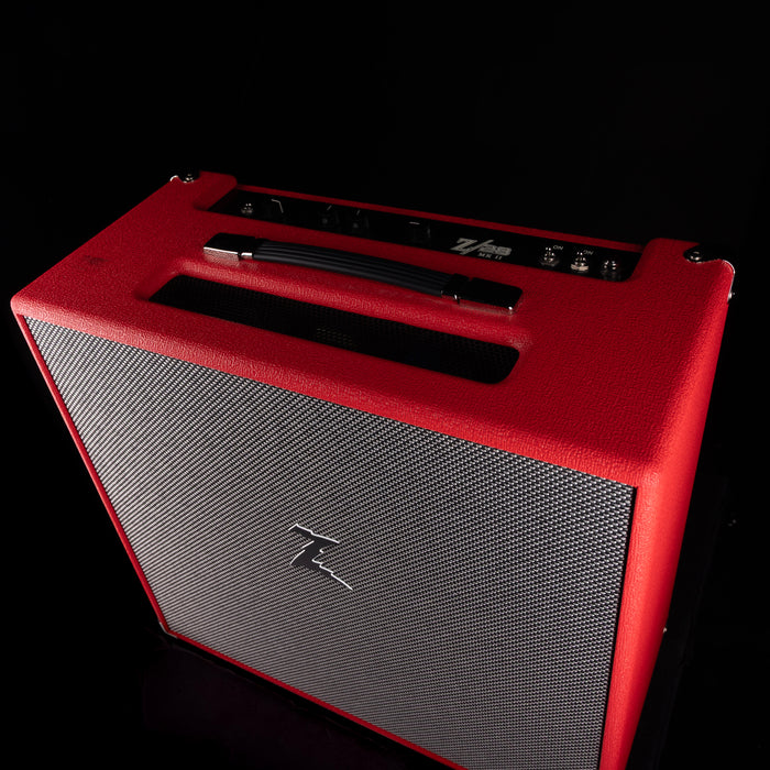 Red and gray guitar amplifier on a black background