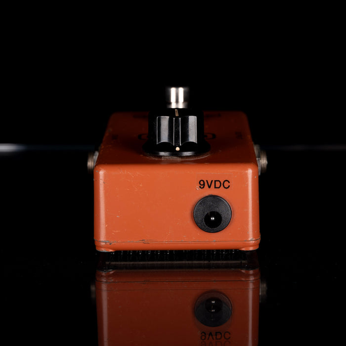 Orange electronic component with '9VDC' label on a black background