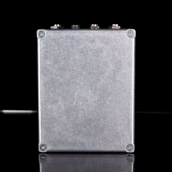 Metallic rectangular box with screws on a black background