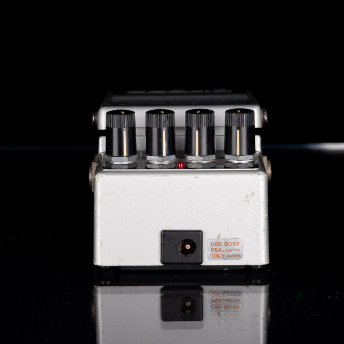 Guitar effects pedal with multiple knobs on a black background