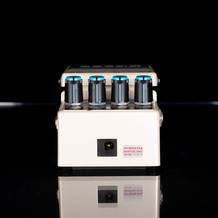 Guitar effects pedal with multiple blue lights on a black background