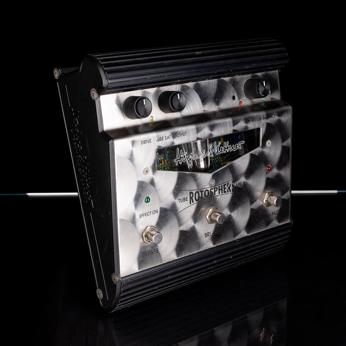Guitar effects pedal with a black and white pattern on a reflective surface