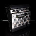 Guitar effects pedal with a black and white pattern on a reflective surface