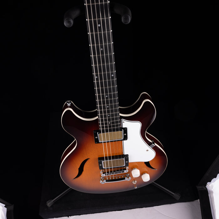 Electric guitar with a sunburst finish on a black background
