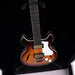 Electric guitar with a sunburst finish on a black background