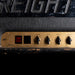 Vintage amplifier with control panel and brand name 'JMP' on a dark background
