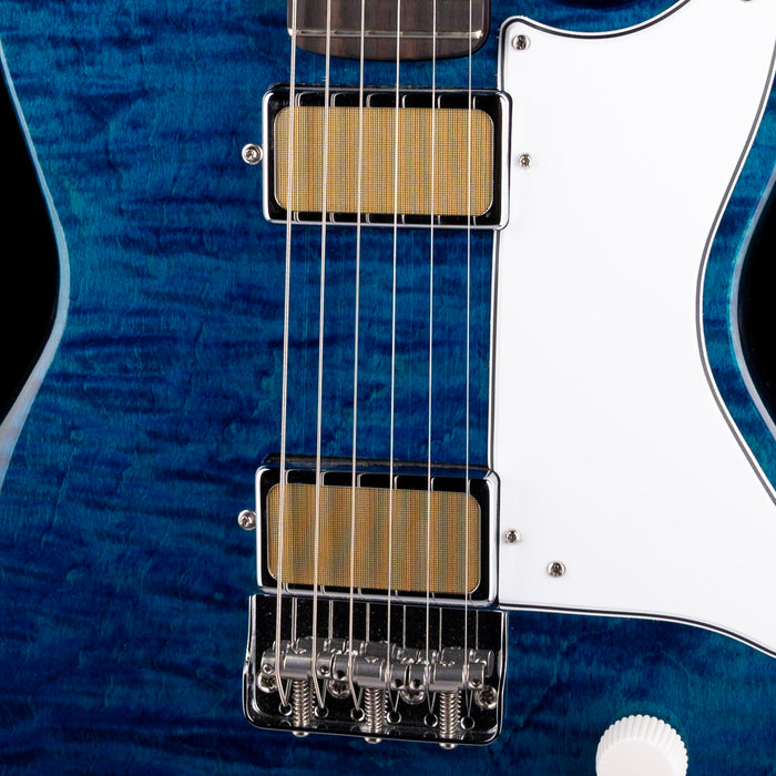 Close-up of a blue electric guitar with a white pickguard