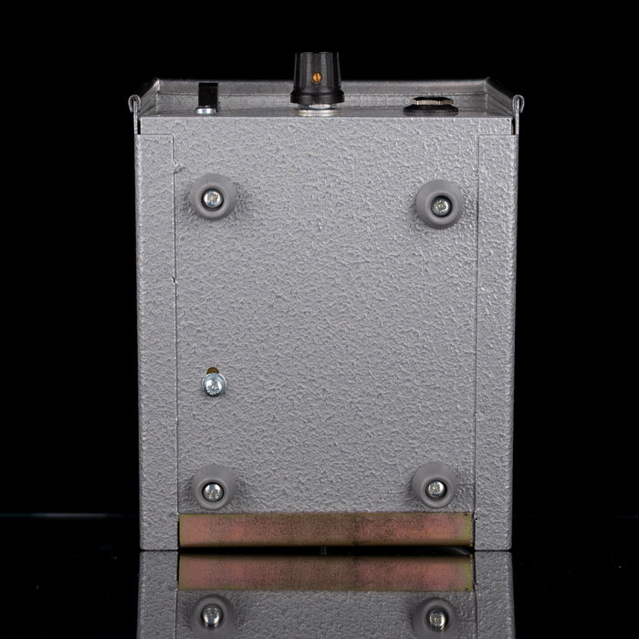 Metallic rectangular object with screws on a black background