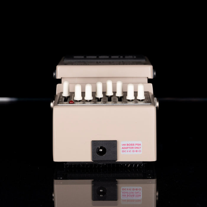 Beige laboratory device with multiple small containers on a black background