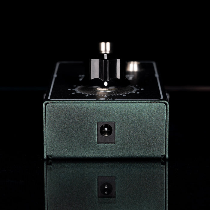 Mechanical component on a reflective surface with a black background