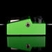 Green guitar effects pedal with black components on a reflective surface