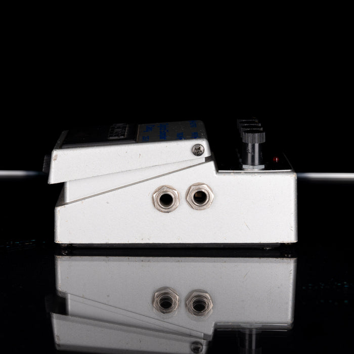 Close-up of a guitar effects pedal with a black background