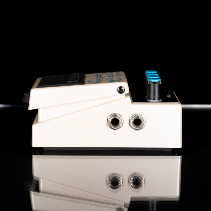 Guitar effects pedal with multiple blue lights on a black background