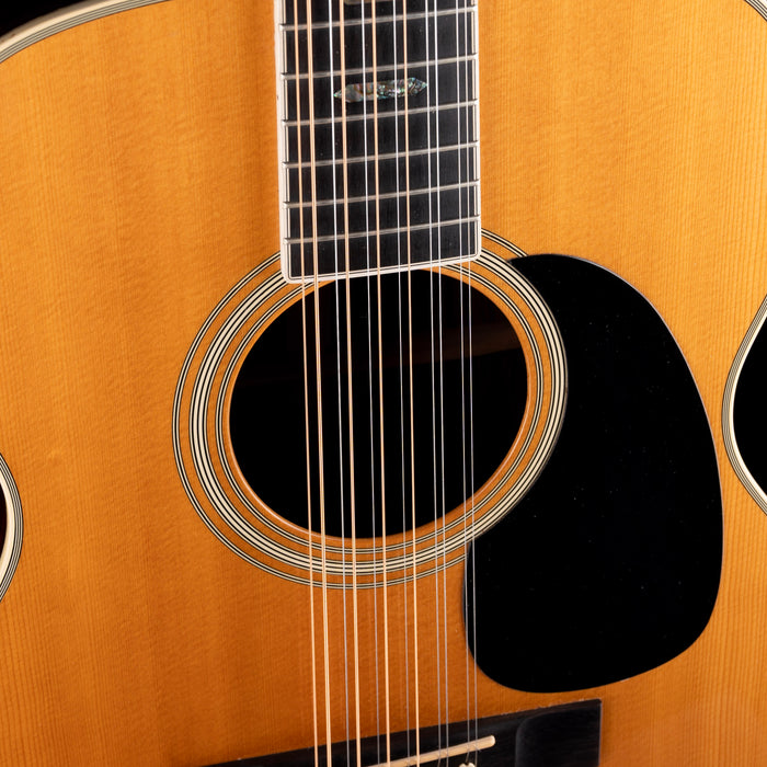 Close-up of an acoustic guitar with a focus on the soundhole and strings.