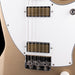 Close-up of a guitar's neck and headstock with a white pickguard and beige body.