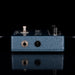 Blue guitar effects pedal with visible brand name on a black background
