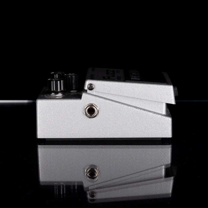 Metallic guitar effects pedal on a black background