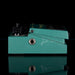 Teal guitar effects pedal on a black background