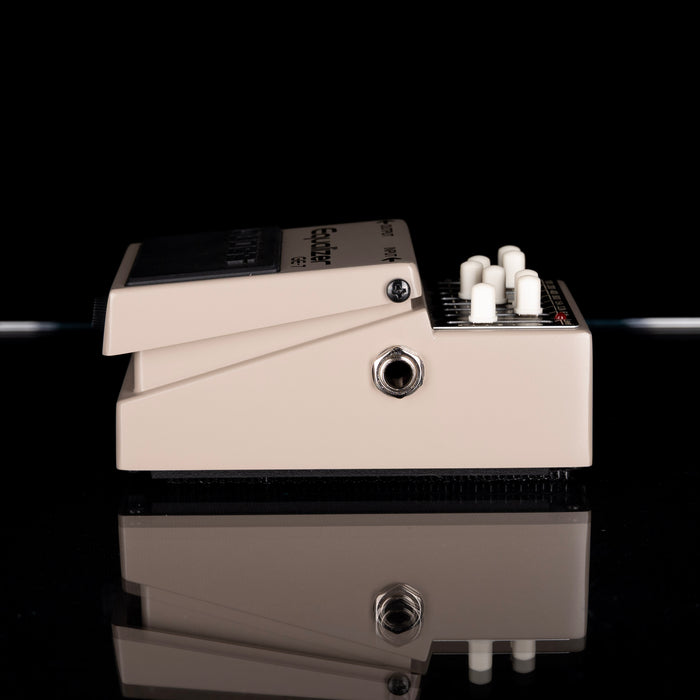 Guitar effects pedal with control knobs on a black background