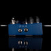 Blue audio interface with knobs and labels on a black background
