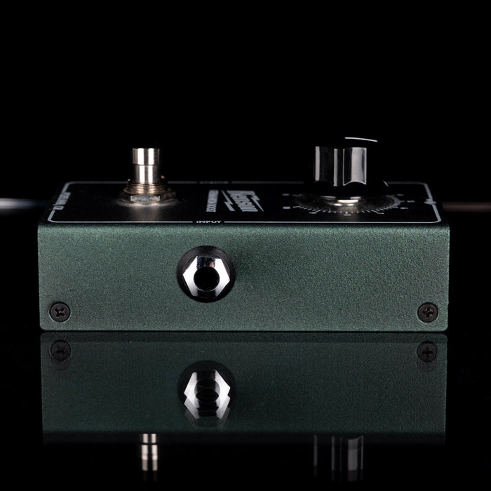 Guitar effects pedal with knobs and switches on a black background