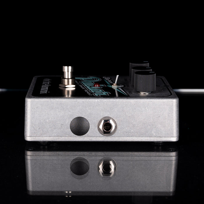 Guitar effects pedal with visible brand name on a reflective surface.