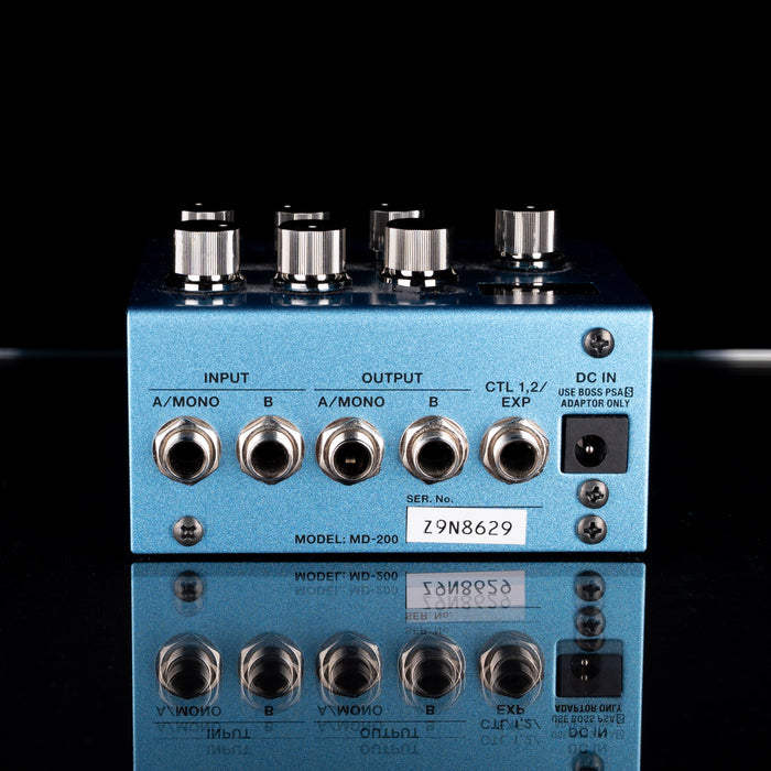 Blue electronic device with various inputs and outputs on a black background