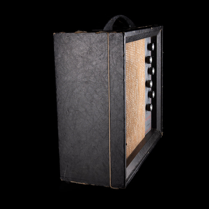 Vintage-style guitar amplifier with a textured black front panel on a white background