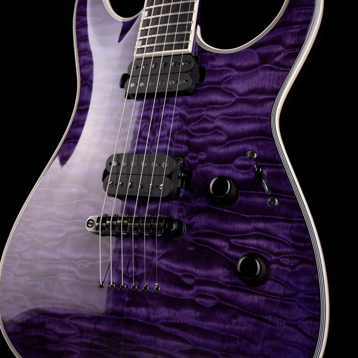 Close-up of a purple electric guitar with a black background