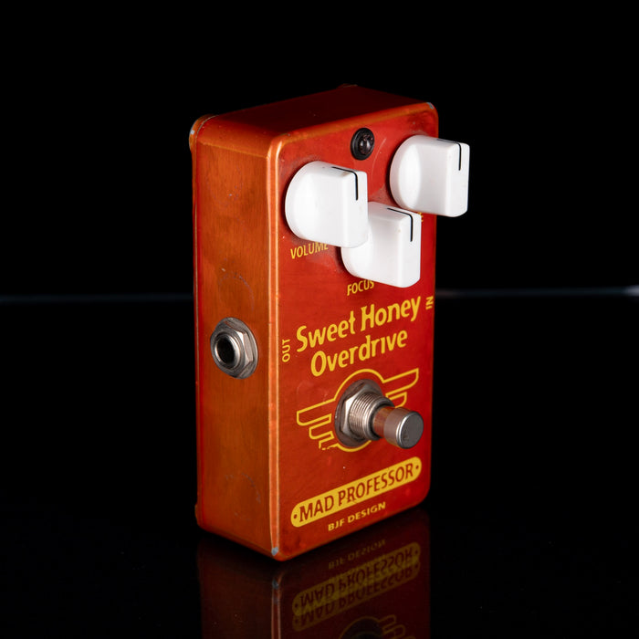 Guitar effects pedal with 'Sweet Honey Overdrive' on a black background