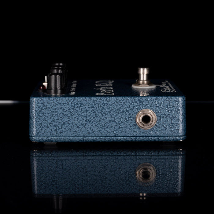 Blue guitar effects pedal with visible branding on a black background