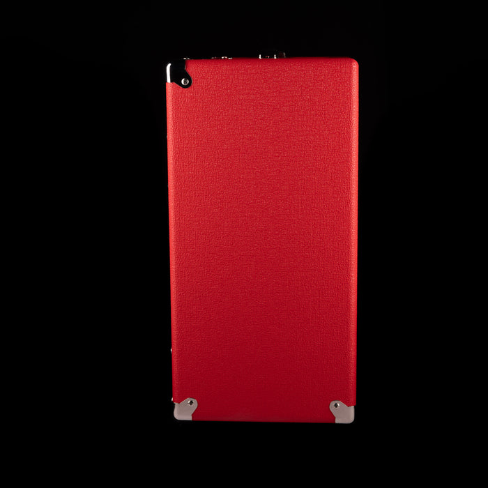 Red rectangular object with textured surface on a black background