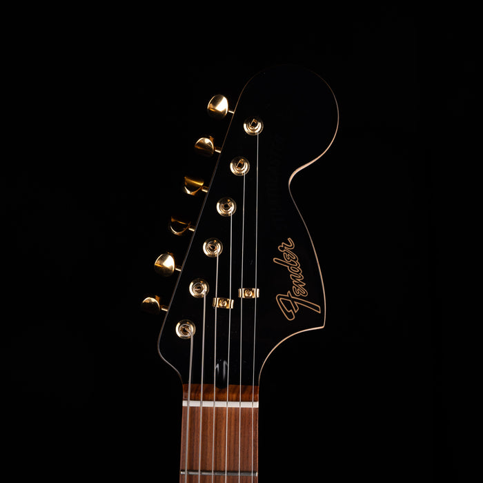 Guitar headstock with Fender logo on a black background