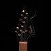 Guitar headstock with Fender logo on a black background