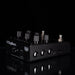 A black DigiTech effects pedal with multiple black and silver knobs, photographed on a glossy black reflective surface against a black background.