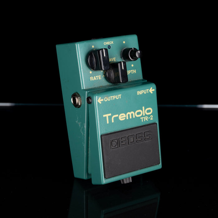 Teal Boss Tremolo TR-2 guitar effects pedal on a black background