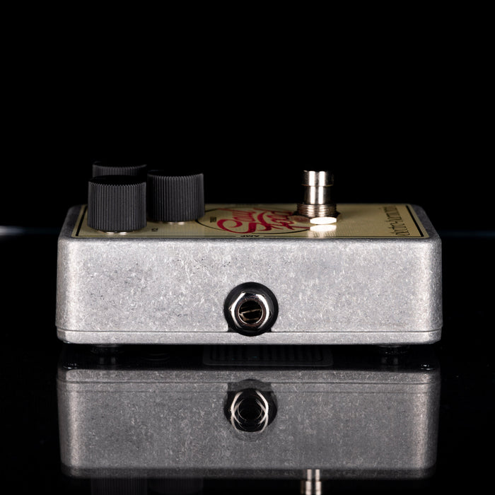 Guitar effects pedal with visible brand logo on a reflective surface