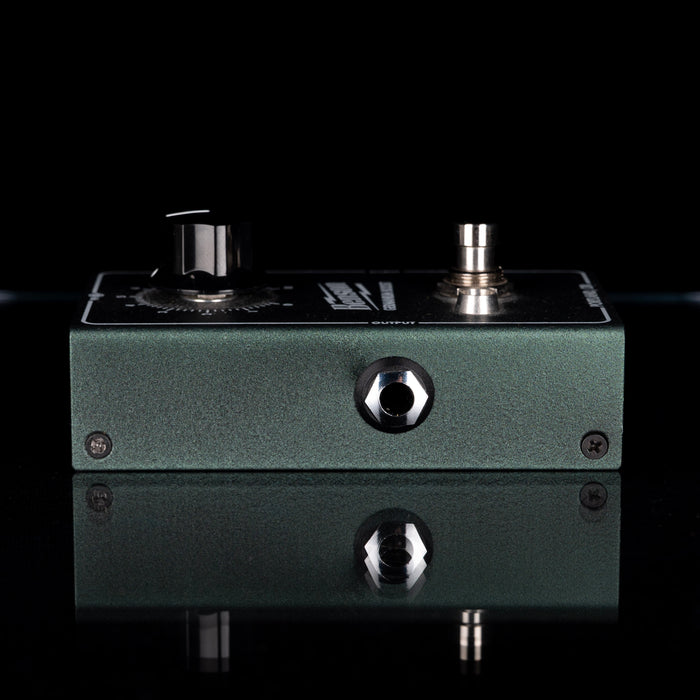 Guitar effects pedal with knobs on a black background