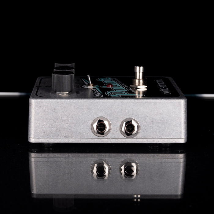 Guitar effects pedal with input and output jacks on a black background