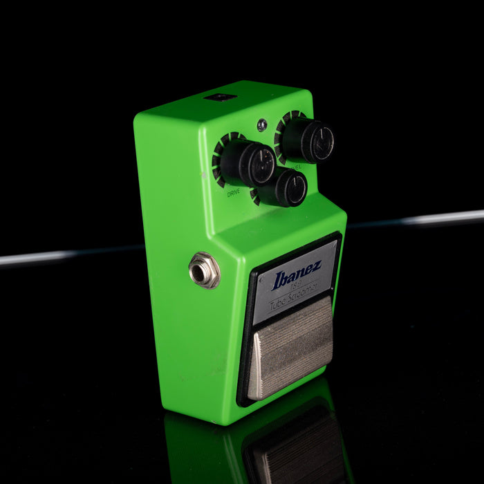 Green guitar effects pedal with Ibanez logo on a black background