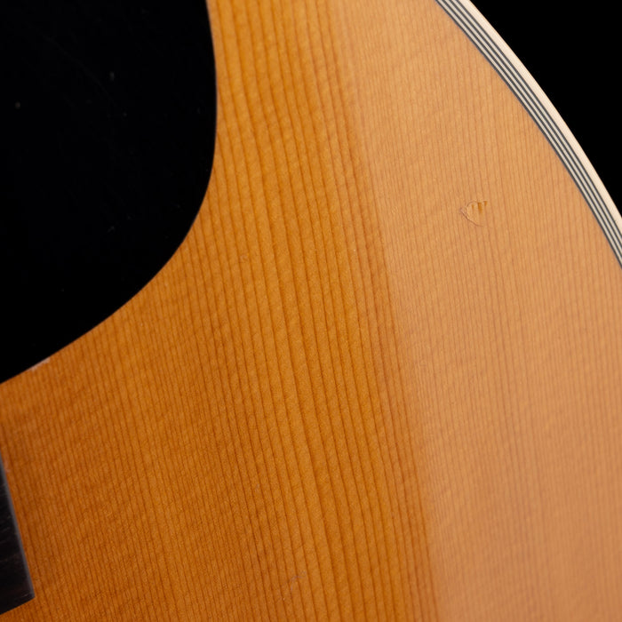 Close-up of a wooden guitar body with a focus on the grain and texture.