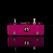 Pink guitar effects pedal with metallic components on a black background