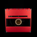 Red speaker cabinet with visible brand logo on a black background
